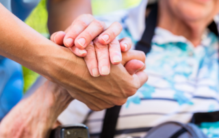 caregiver holding hands with client