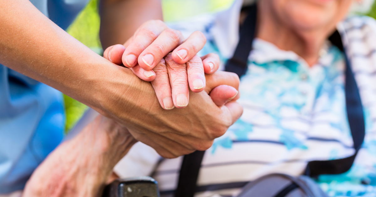 caregiver holding hands with client