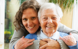 caregiver and client embracing