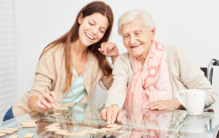 caregiver and client playing dominos